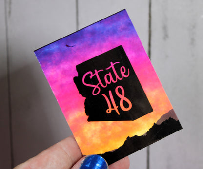 State 48 with gradient backdrop of a sunset on mountains - beautiful sticker!