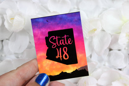 State 48 with gradient backdrop of a sunset on mountains - beautiful sticker!